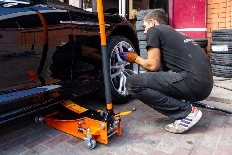 working with a jack in a car service station